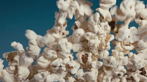 White fluffy pieces of popcorn fall at a slow pace. Stock Footage 105392975