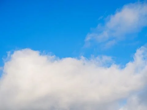 White fluffy soft clouds against a blue sky Stock Photos