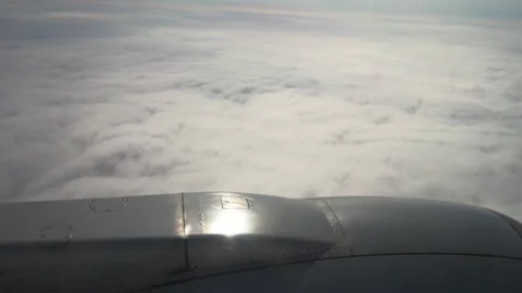 White fluffy soft clouds from airplane window in sunny sky and jet turbine. Stockbeeldmateriaal 232961172