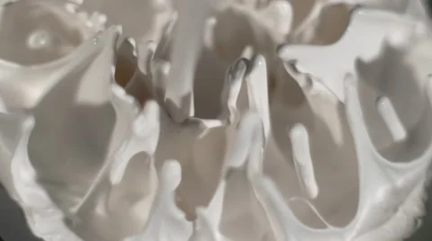 White fluid pulses on top of a speaker, the fluid creates patterns and texture Stock Footage 63992858