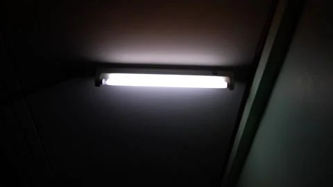 White fluorescent lighting flickers on and off and one bulb in the building or h Video stock 162110760