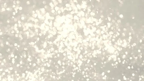 White flying glitter on a beige background. Live wallpaper. Horizontal video. Vidéo 235009850