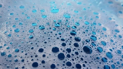 White foam with bubbles popping in deep blue water. Stock Footage 194842083