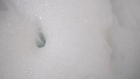White Foam With Bursting Bubbles. Preparation for taking a bath. Water. Flake Stock Footage 146652341