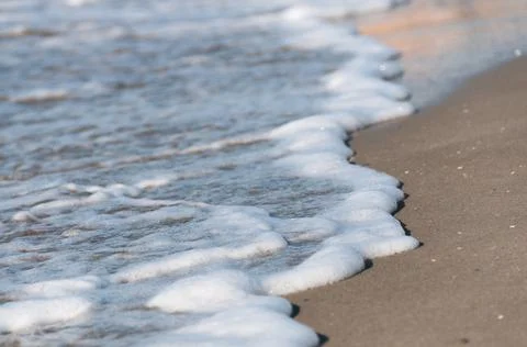 White foam of a soft wave Stock Photos