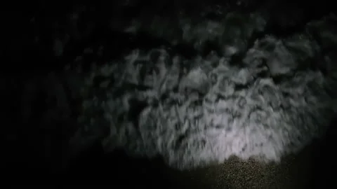 White foam of the surf in a spot of light. View from above Stock Footage 151136448