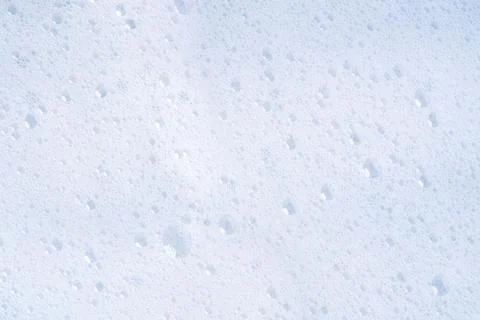 White foam texture with bubbles top view. Cosmetic soapy substance with bubbles. Stock Photos