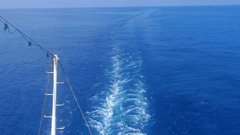 White foam trail wake in deep blue ocean water behind cruise ship or ferry b Video stock 337446915
