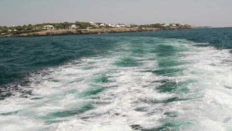 White foam wake trailing behind a moving boat Stock Footage 343439437