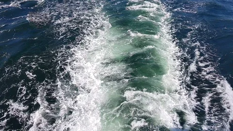 White foaming waves after sailing vessel on calm blue sea Stock Footage 113800880