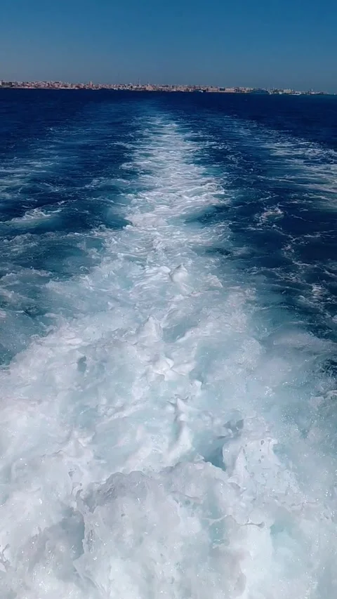 White foamy boat wake trail in deep blue sea in Hurghada slow motion 스톡 동영상 341314624