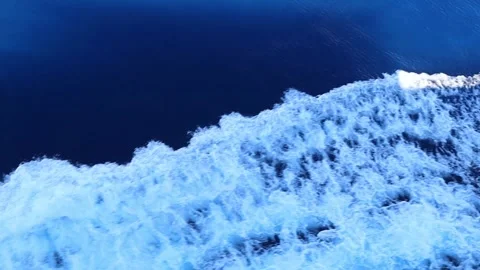 White Foamy Wake of a Moving Boat Churning on Deep Blue Sea Water Stock Footage 345139346
