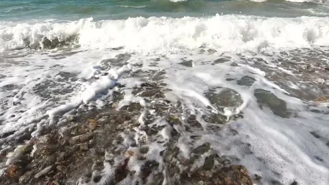 White foamy waves ocean splashing on seashore with Low angle Stock Footage 235583557