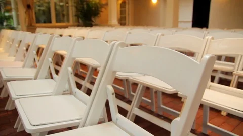 White folding chairs set up inside slider foward then backward Stock Footage 92183579