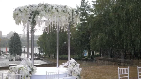 White folding chairs at the wedding ceremony with drops from the rain. Wet seat Stock Footage