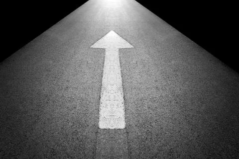 White forward arrow sign on grey asphalt road Stock Photos
