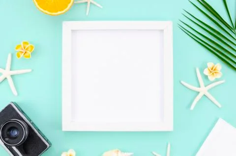 White frame with copy space, oranges, starfishes and retro camera. Top view Stock Photos