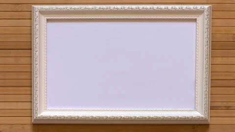White frame with empty white canvas on natural bamboo wall. Foto stock