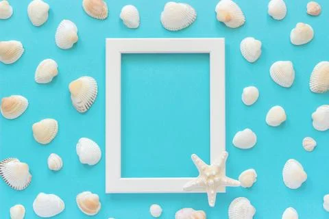 White frame with starfish on blue background and seashells. Creative Flat lay Stock Photos