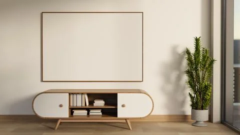 White frame on wall over bookshelf drawer table and pot plant on wooden par.. Ilustración de archivo