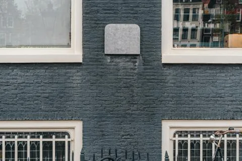 White framed windows on gray wall facade Stock-Fotos