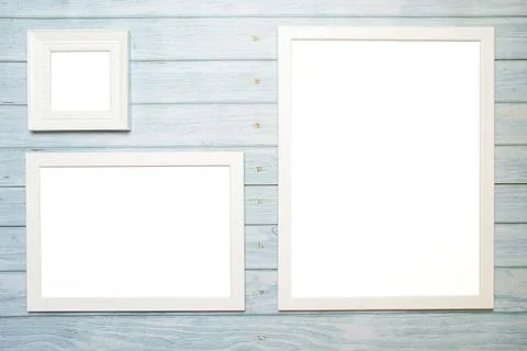 White frames for a picture with copy space on a wooden turquoise background for Foto stock