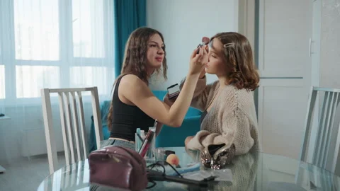 White Freelancer Applying Makeup To Friend, Practicing Brow Shaping And Blush Stock Footage 327022747