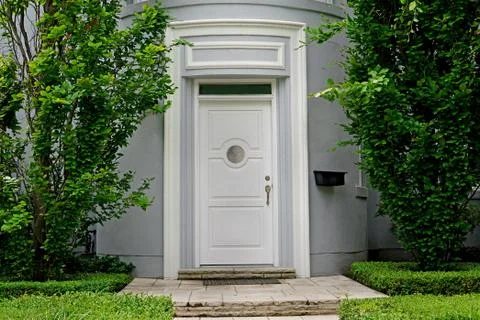 White front door framed by trees Stock Photos