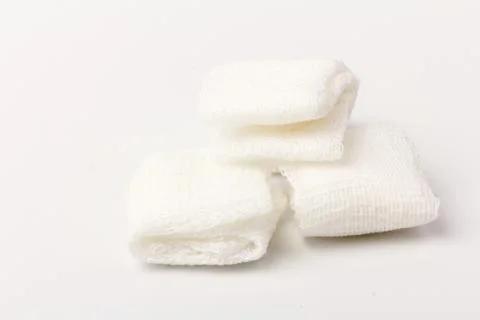 White gauze pads on white background. Materials for dental surgery. Close up Stock Photos