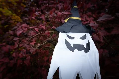 A white ghost with a menacing face and a black witch&amp;#039;s. Stock Photos