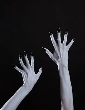 White ghost or witch hands with sharp black nails, body art Foto stock