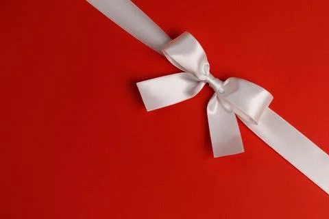 White gift bow on red Stock Photos