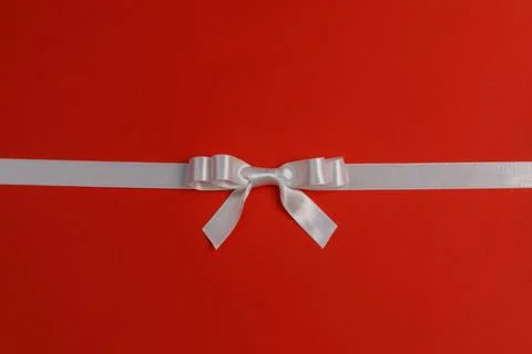 White gift bow on red Stock Photos