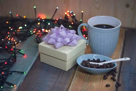 White gift box, blue cup, coffee beans in blue pial Stock Photos