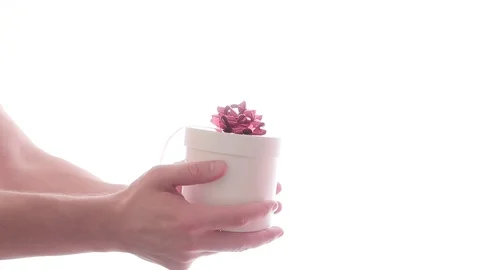 White gift box cylindrical shape with red bow in male hand on white background 動画素材 125876209