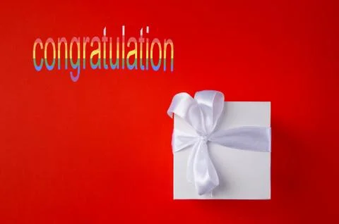 White Gift box on a red background. Space for text. Stock Photos