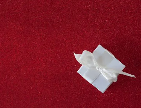 White gift box on the red background Stock Photos