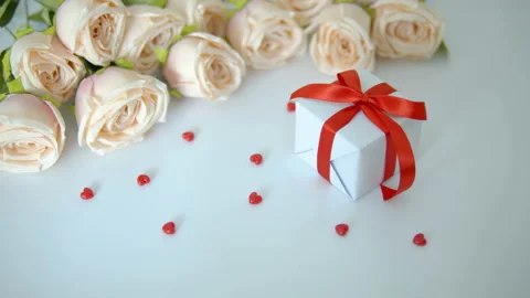 White gift box, red heart and roses on white table for valentine day concept Stock Footage 146764442