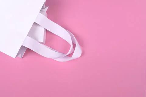 White gift box in white gift bag on pink background Stock Photos