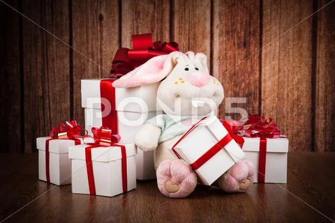 White gift boxes and soft toy on a wood Stock Photos