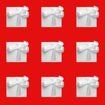 White gift boxes on red background. Seamless pattern, holiday concept Stock Photos