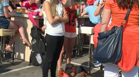White girls outside stadium, talking and smiling Stock Footage 47862401