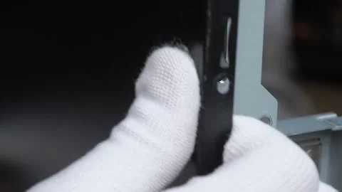 A white gloved hand puts the side cover on the PC case Stock Footage 131094962