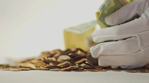 White-gloved hands scooping up a pile of gold coins. They sort out and scatter Stock Footage 122662947