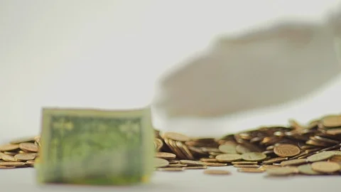 White-gloved hands scooping up a pile of gold coins. They sort out and scatter Stock Footage 122663255