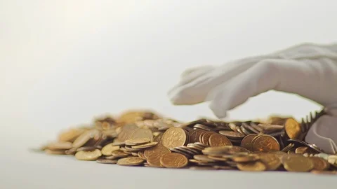 White-gloved hands scooping up a pile of gold coins. They sort out and scatter Stock Footage 122663990