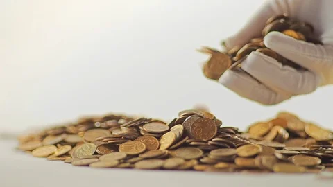 White-gloved hands scooping up a pile of gold coins. They sort out and scatter Stock Footage 122665716