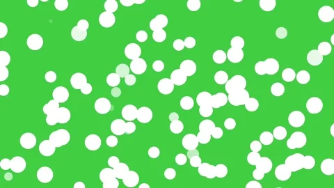 White glowing bokeh particles floating across a vivid green chroma key Stock Footage 338187220
