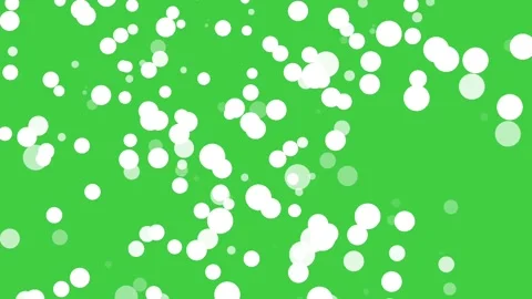White glowing bokeh particles floating across a vivid green chroma key Video stock 339198529