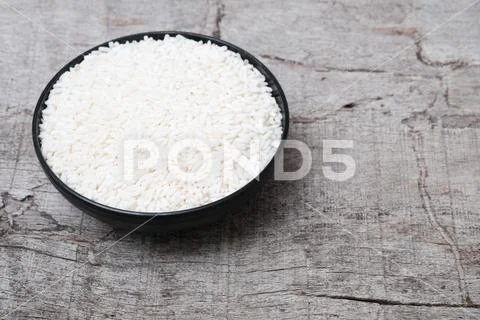 White glutinous rice isolated on wooden background. Stock Photos